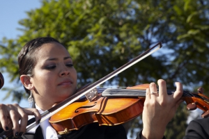 Hispanic woman plays violin at Day of the Dead (Dia de los Muertos) at Hollywood Forever Cemetery