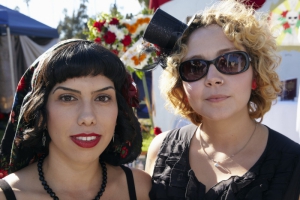Hispanic woman and white woman  dressed in costume at Day of the Dead (Dia de los Muertos) at Hollywood Forever cemetery