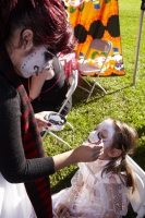 Woman paints girls face at Day of the Dead (Dia de los Muertos) at Hollywood Forever cemetery