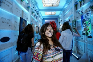 Woman in costume stands in mausoleum at Day of the Dead (Dia de los Muertos) at Hollywood Forever cemetery