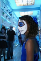Girl in costume stands in mausoleum at Day of the Dead (Dia de los Muertos) at Hollywood Forever cemetery