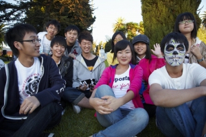 Group of Japanese students laugh  together at Day of the Dead (Dia de los Muertos) at Hollywood Forever cemetery